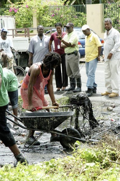 Junior Dowie / Staff Photographer
Kingston Mayor Desmond McKenzie third right with the Press and Members of His Party watch clean up begins on Maiden Lane