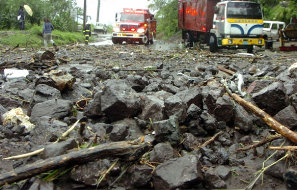 Norman Grindley
A fire truck rushes to help marooned residents in Mammee River, St Andrew but first has to get by a large piles of rock and silt.
.