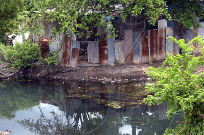 Norman Grindley /Deputy Chief Photographer 
The Duhaney river is rising near to sevral homes in New Heaven in St. Andrew yesterday.